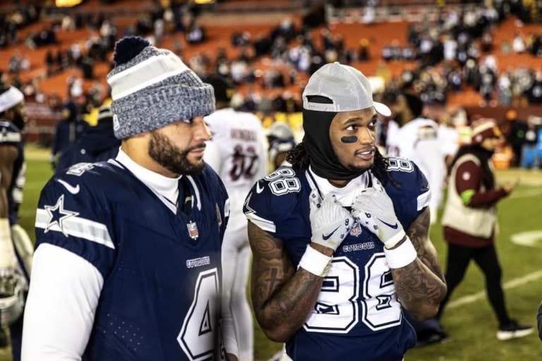 CeeDee Lamb (right) taking a photo with his teammates on the field